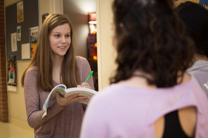 A social work student interviewing two other students